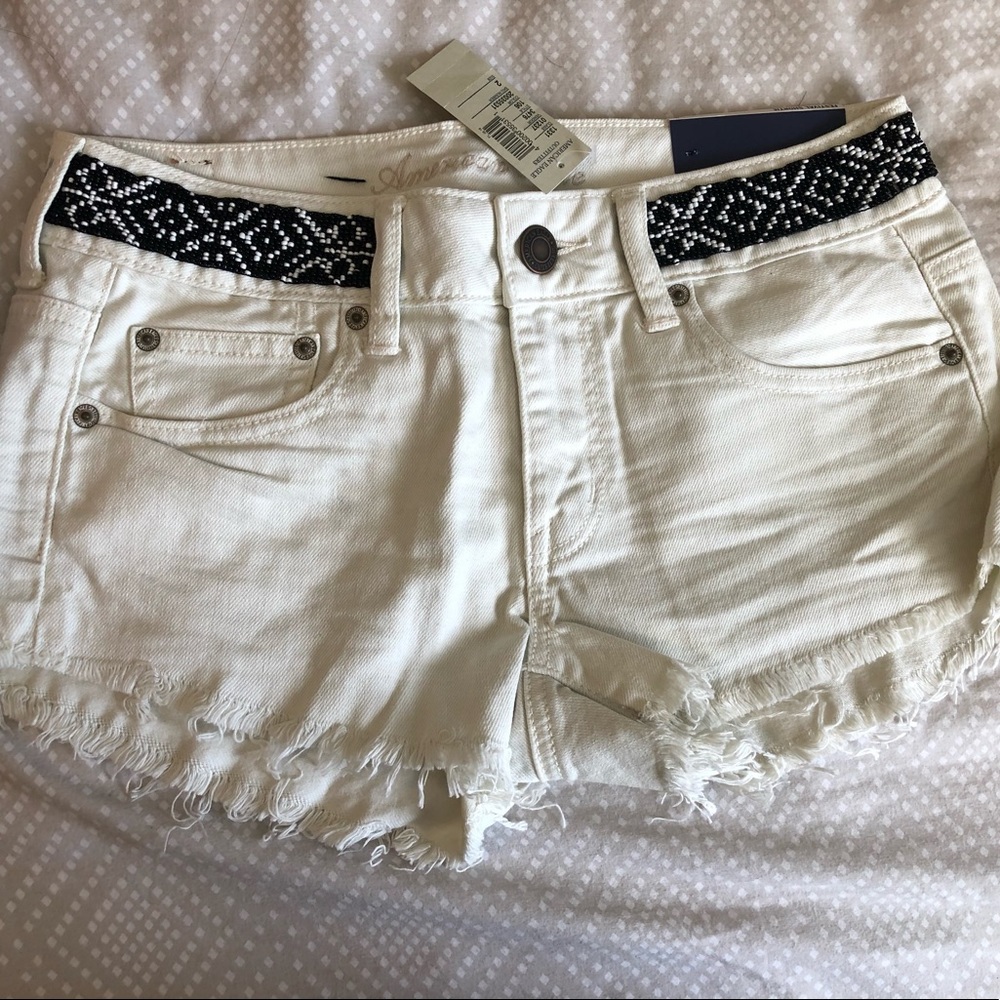Never worn Size 2 white American Eagle Jean shorts with beaded waistband